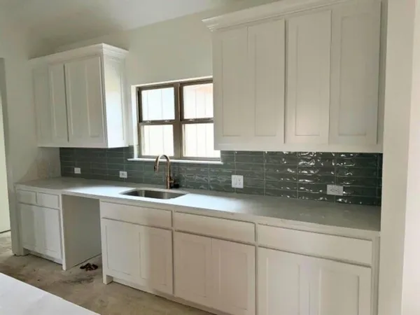 a kitchen with a sink and cabinets