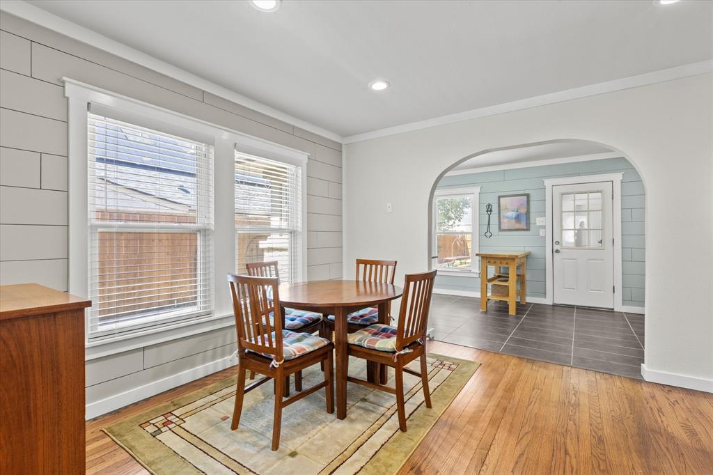 2919 Maple Springs Boulevard Dallas, TX 75235 - Photo 13 of 26 a view of a dining room with furniture window and wooden floor