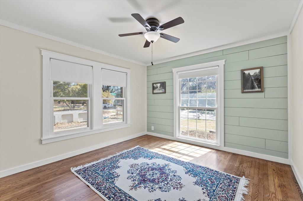 2919 Maple Springs Boulevard Dallas, TX 75235 - Photo 21 of 26 a view of an empty room with a window and wooden floor
