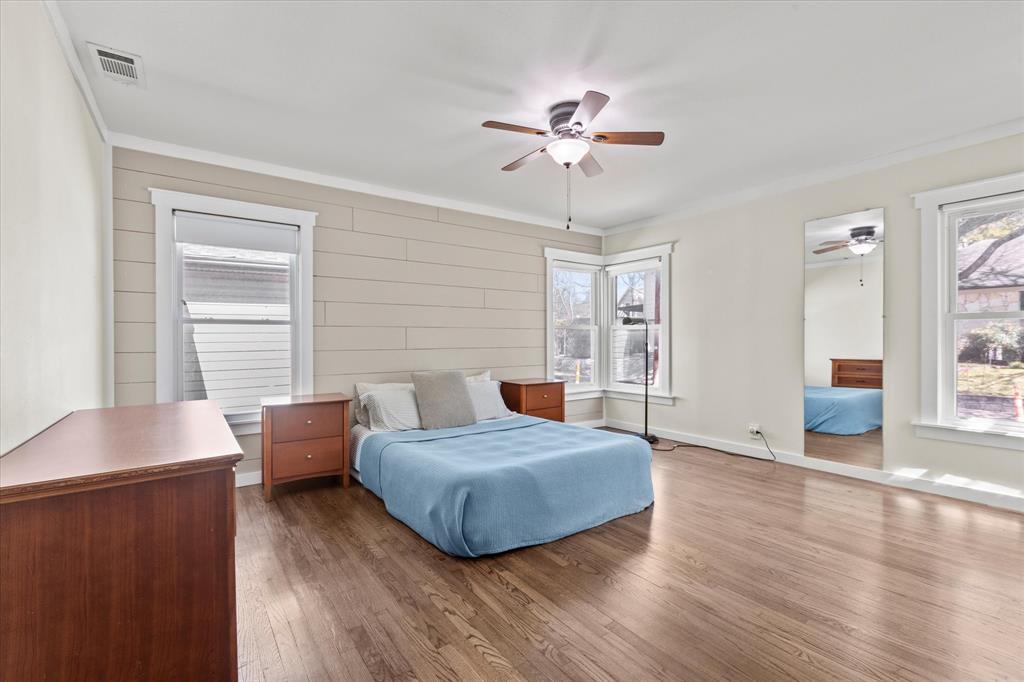 2919 Maple Springs Boulevard Dallas, TX 75235 - Photo 25 of 26 a bedroom with furniture and wooden floor