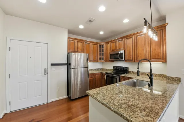 a kitchen with refrigerator cabinets and wooden floor