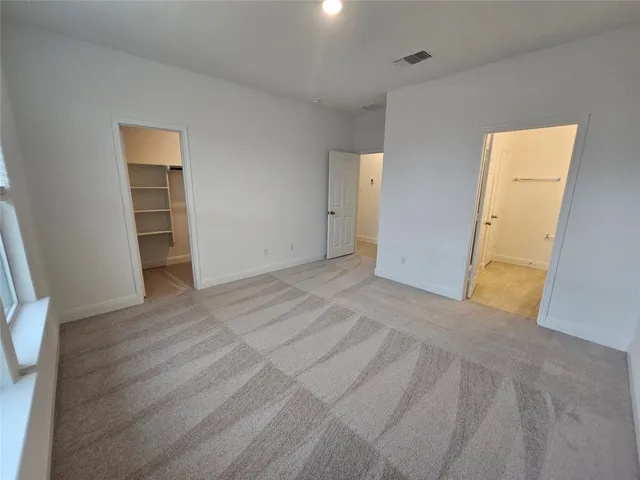 a view of empty room with wooden floor and cabinet
