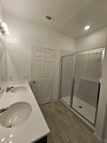 a bathroom with a sink a mirror and shower
