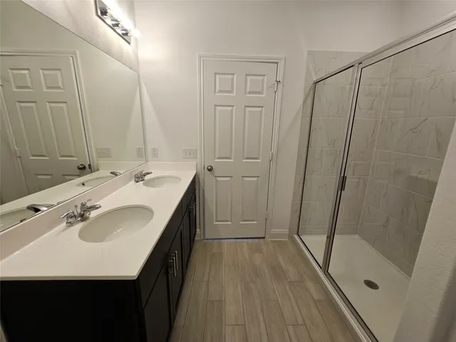 a bathroom with a sink a mirror and shower