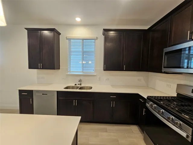 a kitchen with a sink and a stove top oven