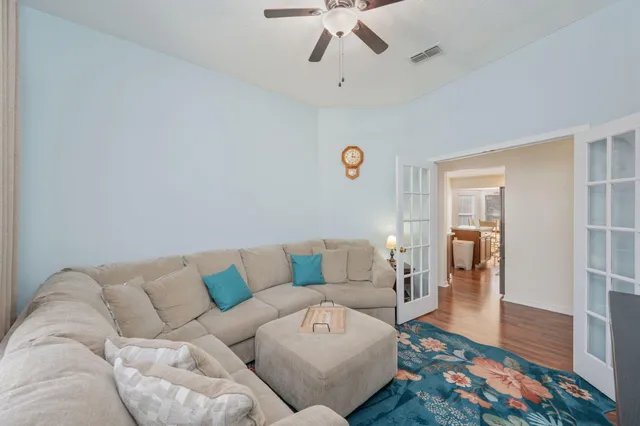 a living room with furniture and wooden floor
