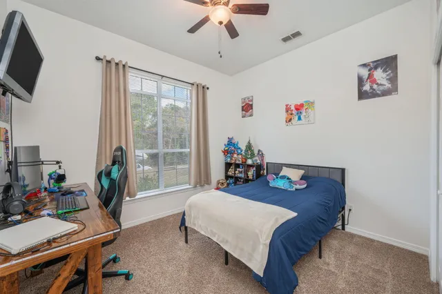 a bed room with a bed and a flat tv screen
