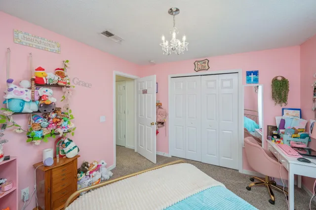 a bedroom with furniture and a chandelier