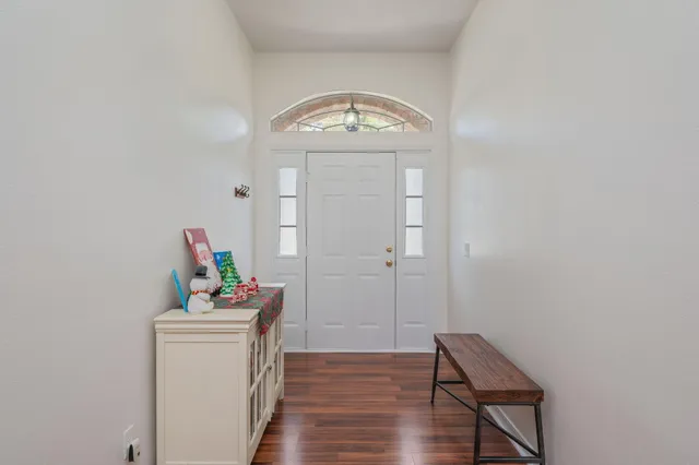 a view of an entryway with wooden floor