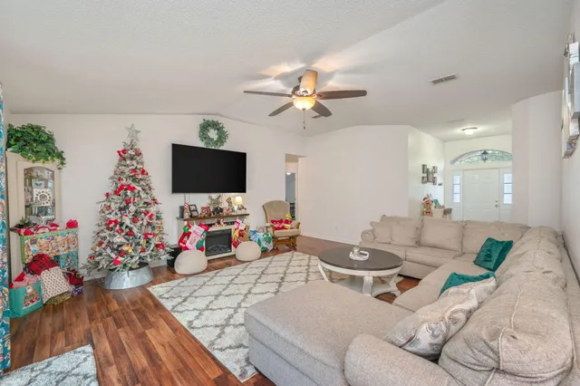 a living room with furniture and a flat screen tv