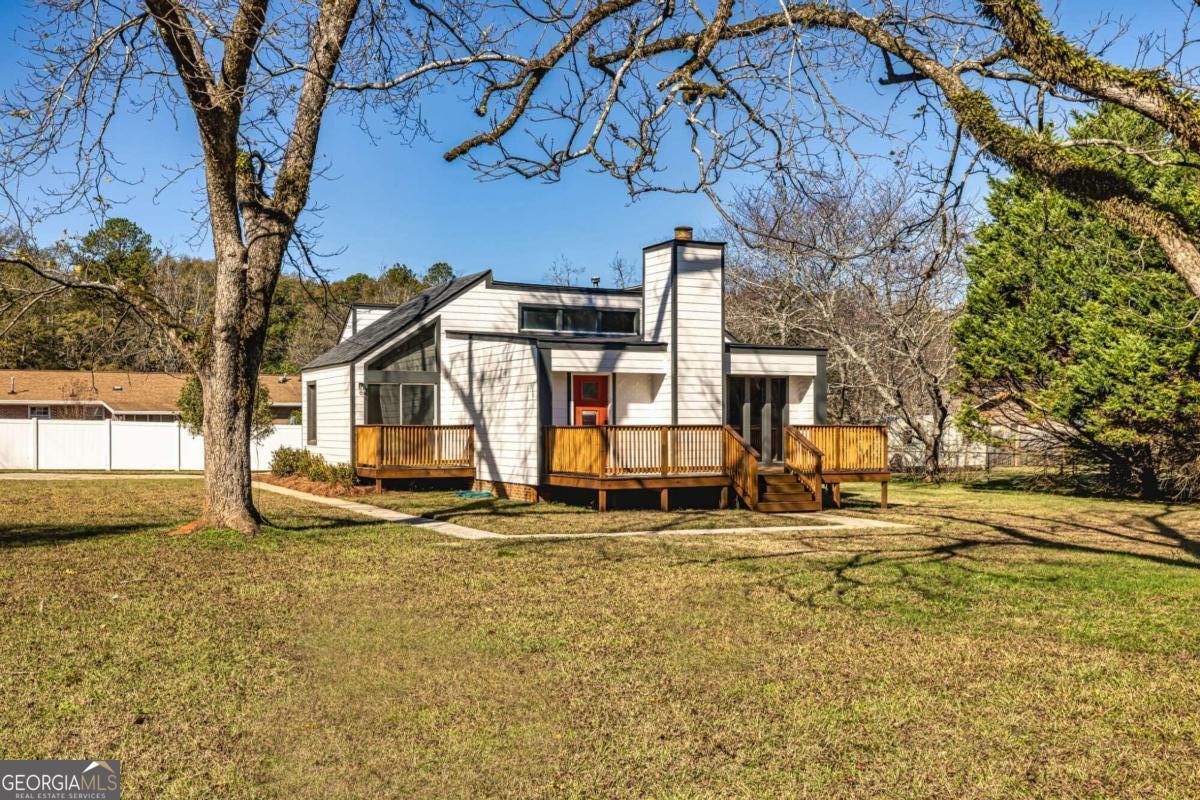 137 Laurel Drive Barnesville, GA 30204 - Photo 1 of 1 a white house that has a tree in front of it