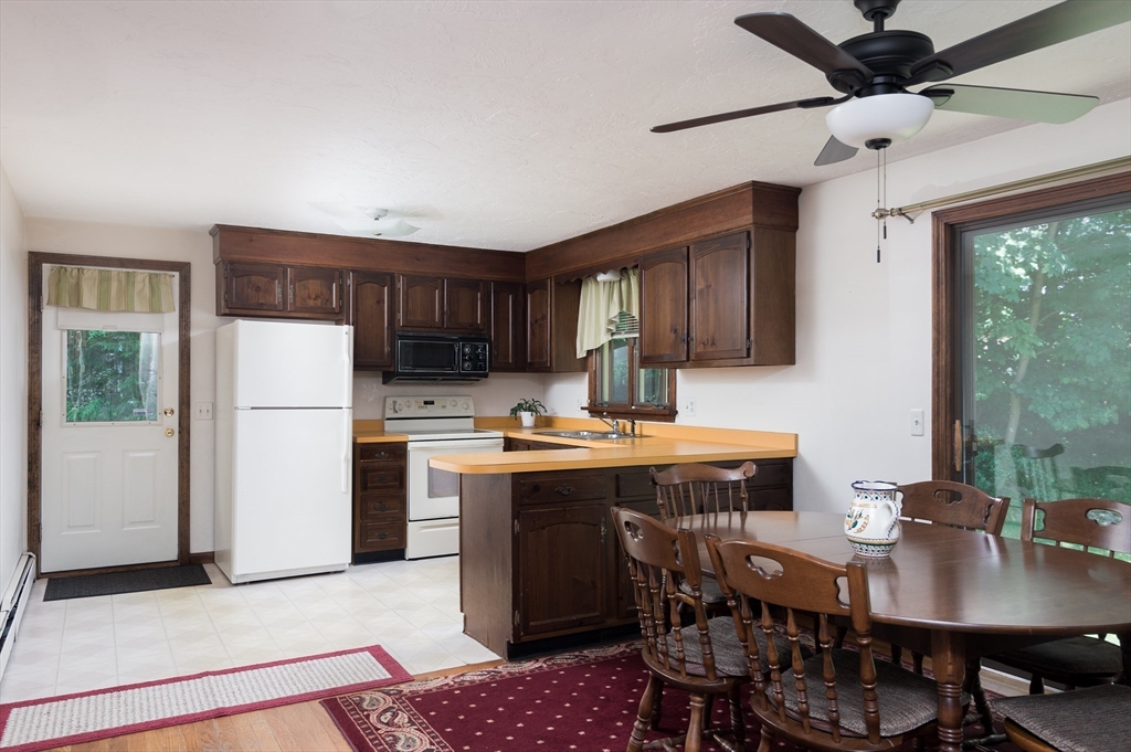 35 Juniper Lane Rutland, MA 01543 - Photo 4 of 15 a kitchen with a table chairs refrigerator and cabinets
