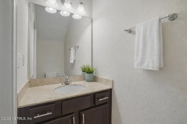 a bedroom with a bed and a chair