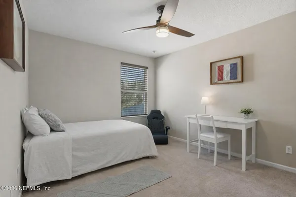 a bathroom with a granite countertop sink a light fixture and a mirror
