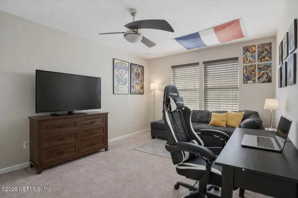 a bedroom with a bed and a desk