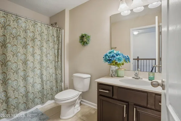 a bathroom with a sink toilet and a mirror