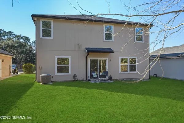 a front view of a house with a garden and yard