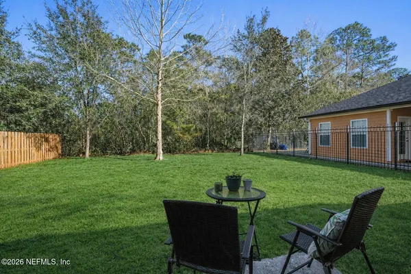 a view of a house with backyard sitting area and garden
