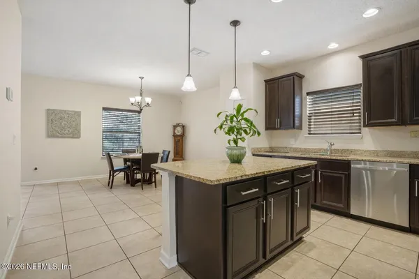 a kitchen with stainless steel appliances granite countertop sink stove top oven and cabinets