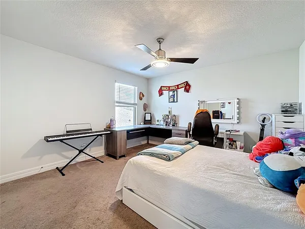 a bedroom with bed and a chandelier
