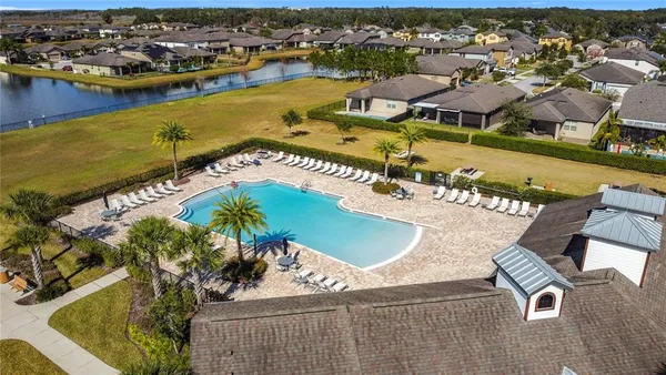 an aerial view of residential houses with outdoor space and swimming pool