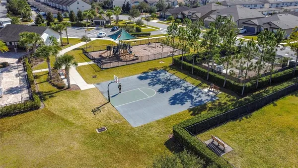 an aerial view of a swimming pool with outdoor seating
