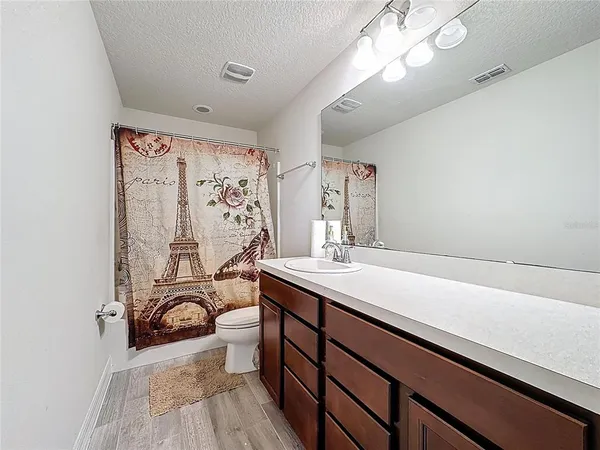 a bathroom with a sink a large mirror and a shower