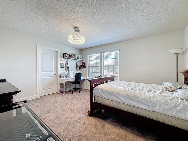 a bed room with a bed and a window