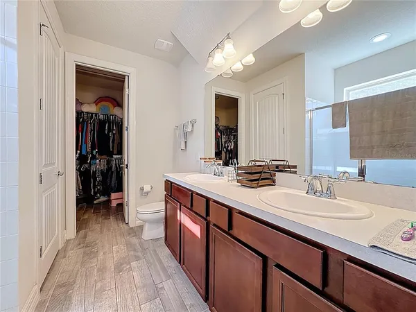 a spacious bathroom with a double vanity sink and a mirror