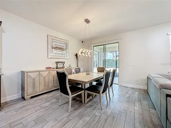 a view of a dining room with furniture window and wooden floor