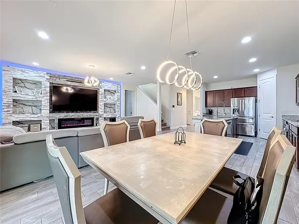 a large kitchen with a table and chairs