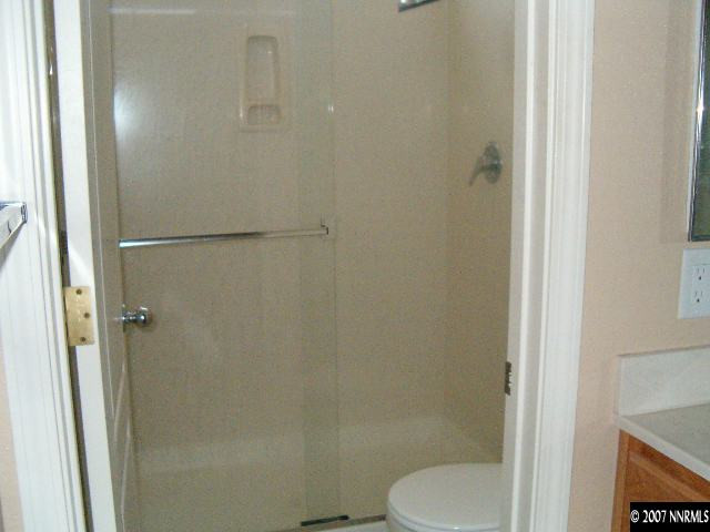 2180 Evergreen Reno, NV 89521 - Photo 7 of 9 a white toilet sitting next to a shower