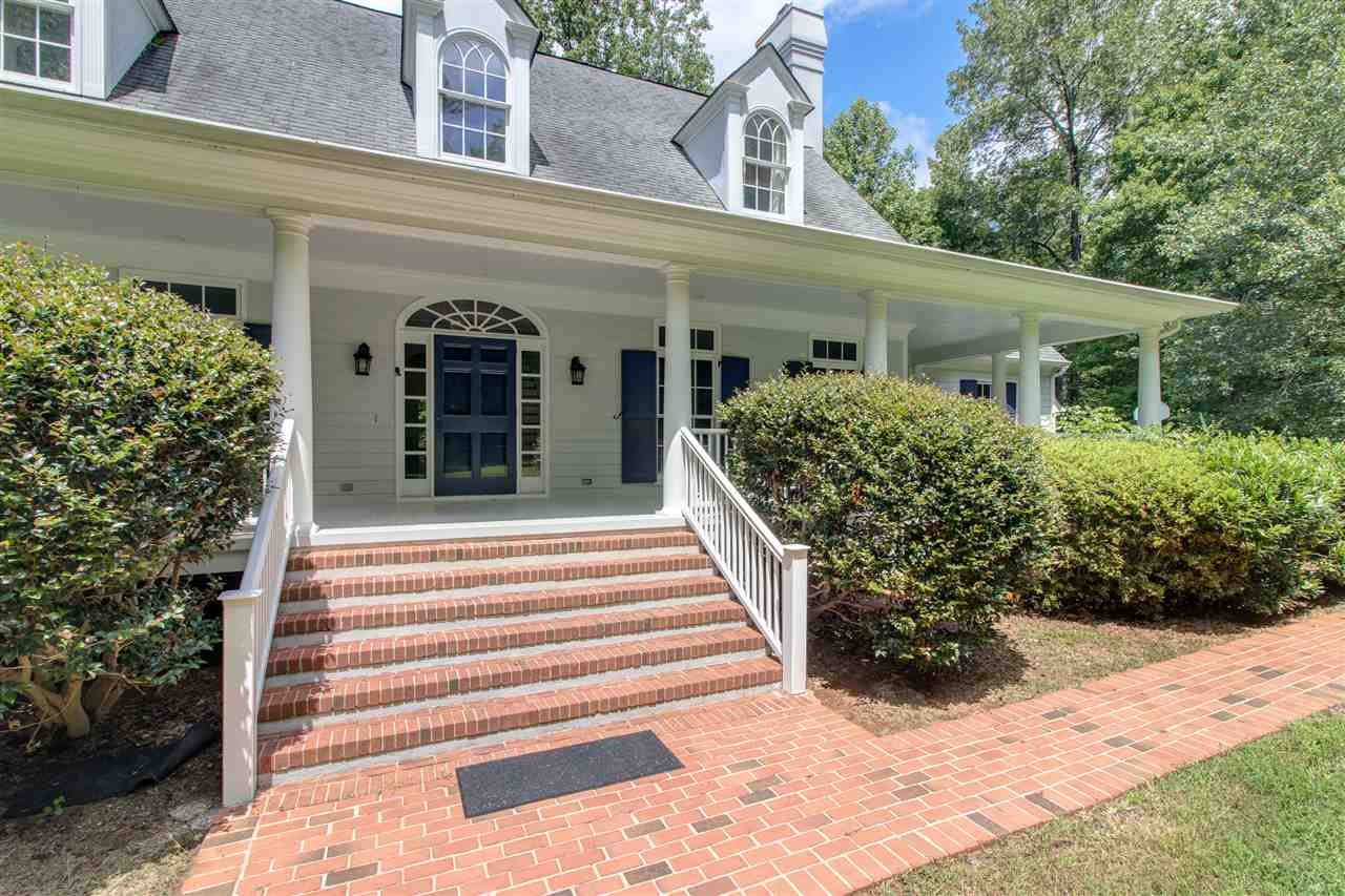 a view of a house with potted plants