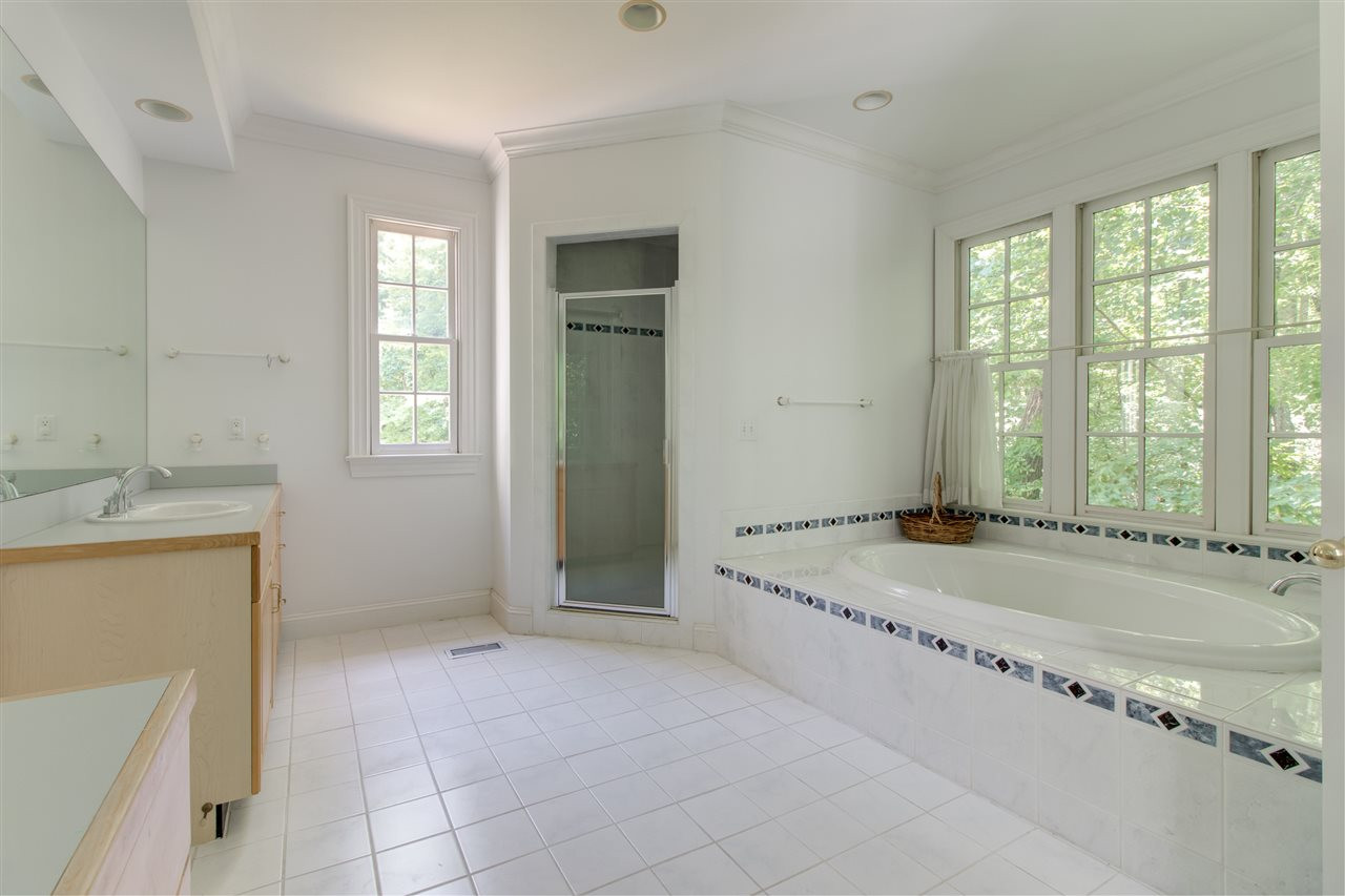 10 Pearse Wynd Road Bahama, NC 27503 - Photo 13 of 29 a bathroom with a granite countertop tub sink and mirror