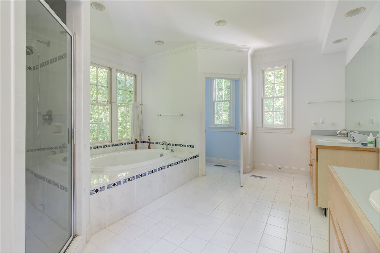 10 Pearse Wynd Road Bahama, NC 27503 - Photo 14 of 29 a bathroom with a tub sink and mirror