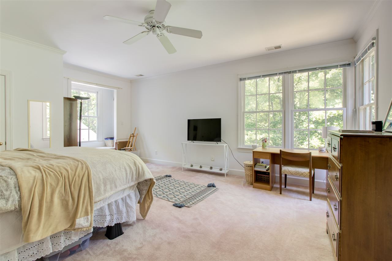10 Pearse Wynd Road Bahama, NC 27503 - Photo 21 of 29 a spacious bedroom with a bed and a table in it