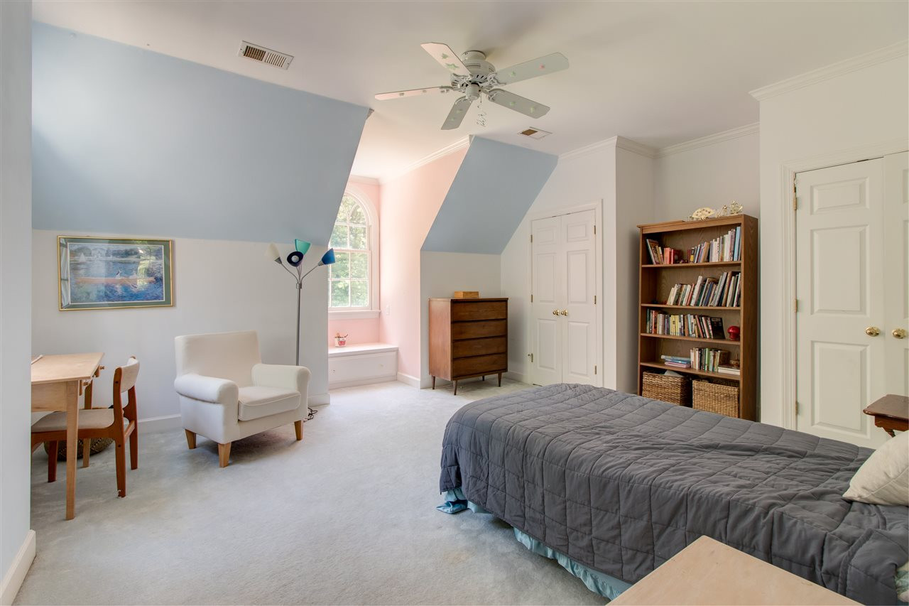 10 Pearse Wynd Road Bahama, NC 27503 - Photo 22 of 29 a bedroom with a large bed and a chandelier