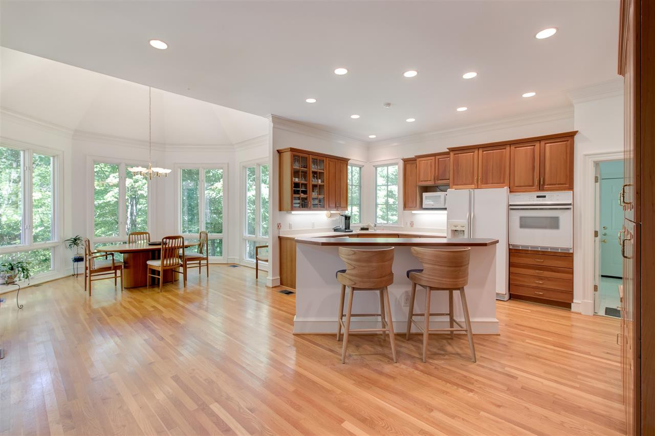 10 Pearse Wynd Road Bahama, NC 27503 - Photo 7 of 29 a kitchen with stainless steel appliances a dining table chairs and wooden floor