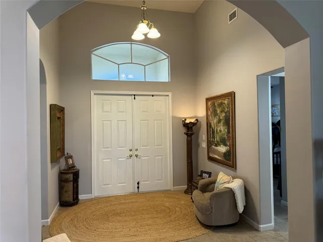 a bedroom with a bed and a chandelier