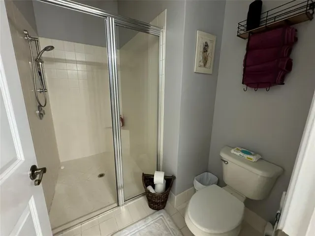 a bathroom with a toilet and a shower