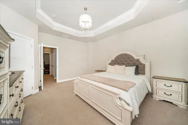 a bedroom with a bed and a chandelier