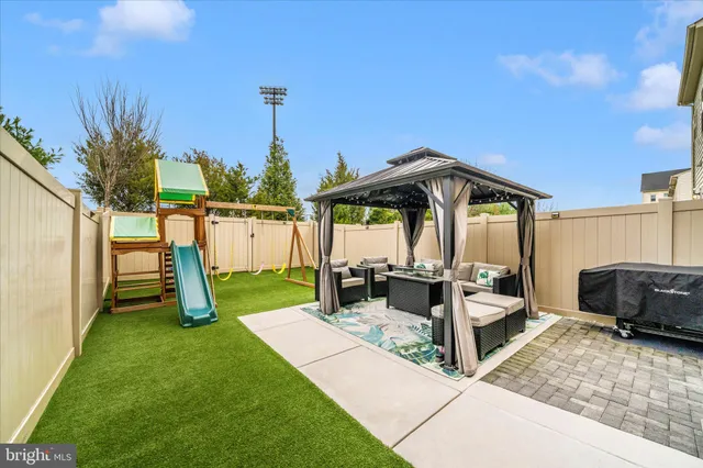 a view of a patio with a table and chairs