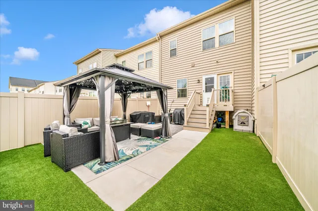 a view of a patio with a table chairs and a yard