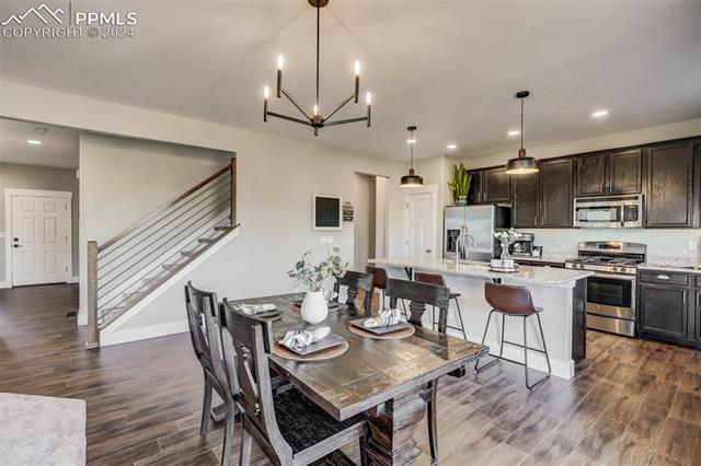 2085 Reed Grass Way Colorado Springs, CO 80915 - Photo 10 of 25 The Oak & Steel staircase and upgraded light fixtures enhance the modern design that's found throughout this home.