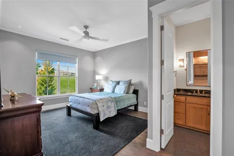 a bed room with a bed window and a dresser