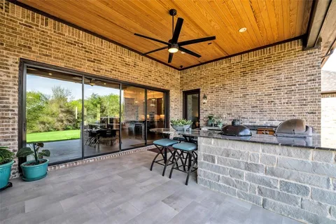 an aerial view of a house with swimming pool and green space