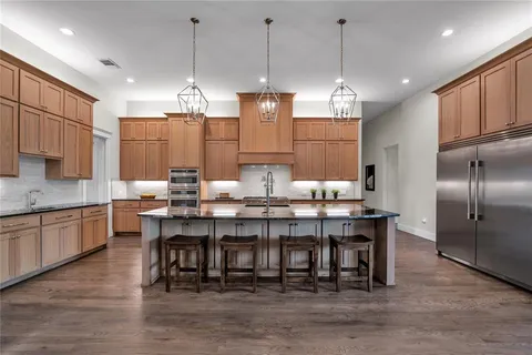 a kitchen with stainless steel appliances a sink and cabinets