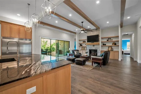 a living room with furniture a large window and a table