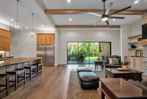 a kitchen with stainless steel appliances and granite countertop a refrigerator