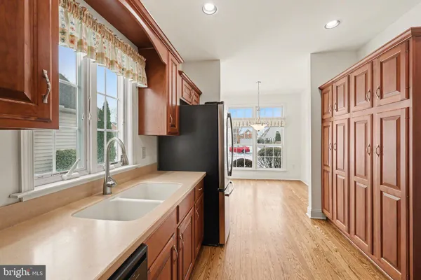 a kitchen with stainless steel appliances granite countertop a sink a stove and a refrigerator